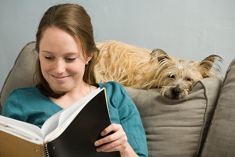 Woman reading with dog